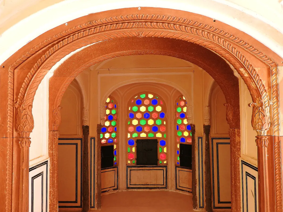 An arch with coloured windows inside the Hawa Mahal