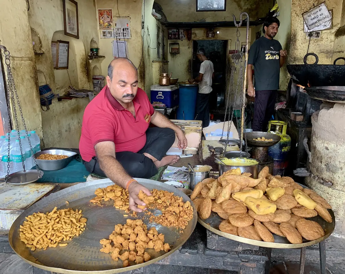 A street food vendor frying snacks
